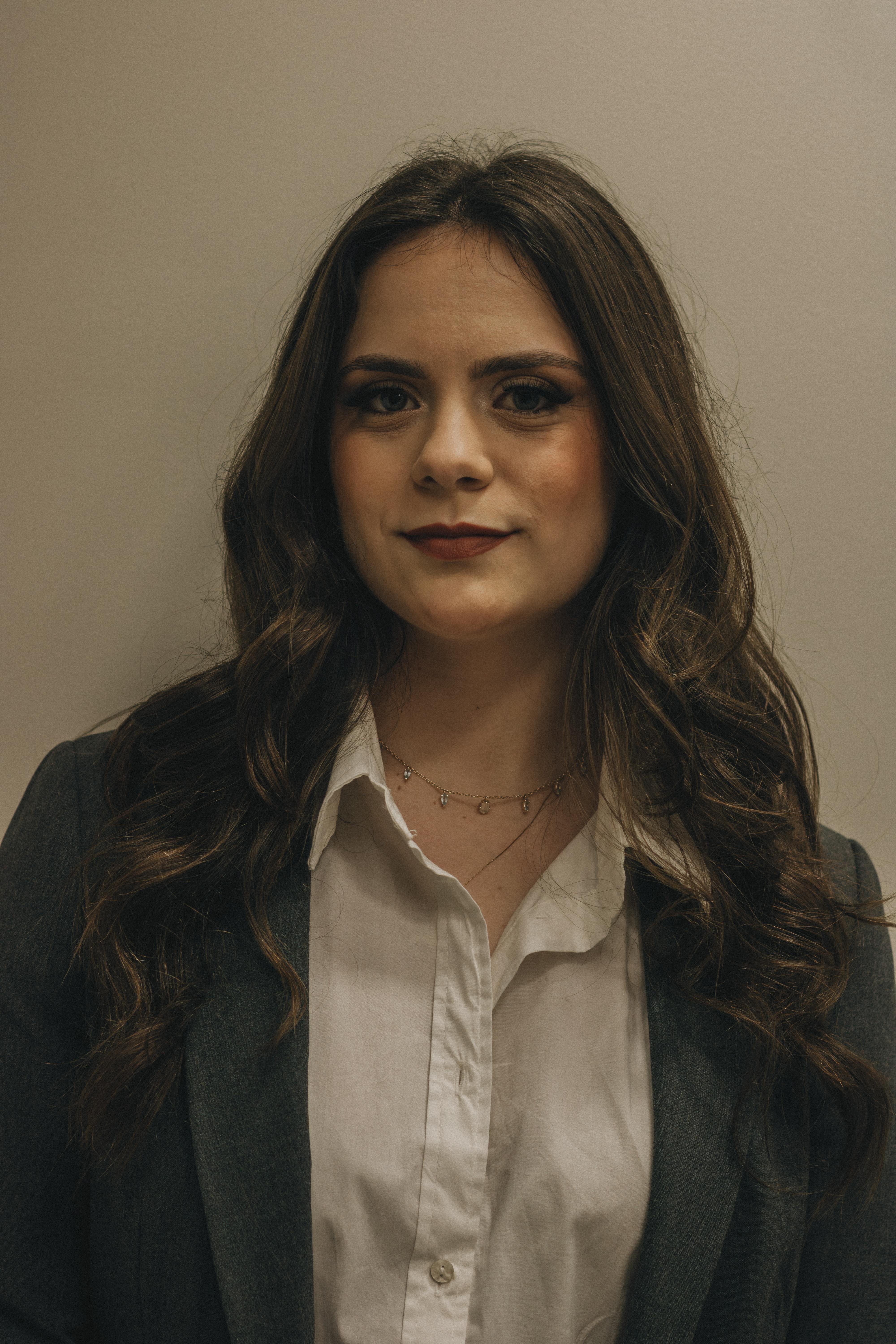 Confident young woman wearing a suit, perfect for corporate and business themes.